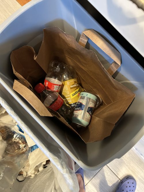 trash bin filled with recyclable cans and bottles